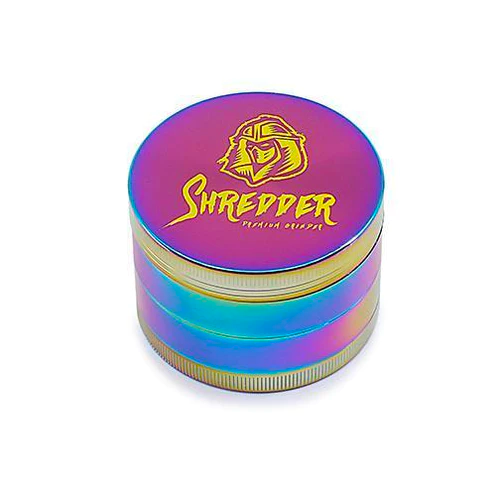 SHREDDER GRINDER - RAINBOW (2")(50MM) Introducing the SHREDDER GRINDER - RAINBOW, a Heavy Duty 4-piece grinder that adds a touch of vibrancy to your herb grinding experience. With a compact 50mm size, this grinder is crafted for durability and precision, ensuring every grind is a masterpiece.