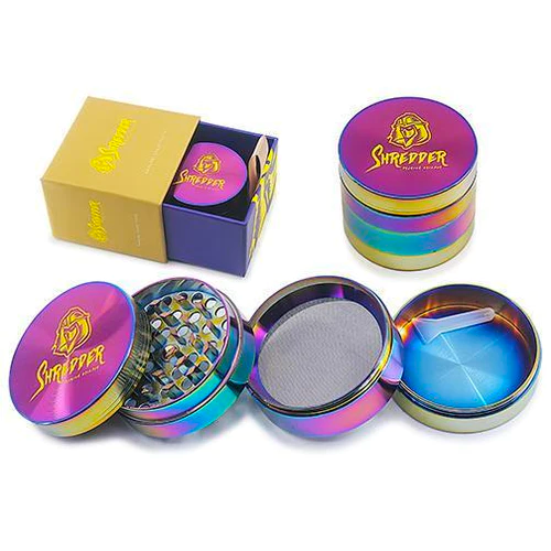 SHREDDER GRINDER - RAINBOW (2")(50MM) Introducing the SHREDDER GRINDER - RAINBOW, a Heavy Duty 4-piece grinder that adds a touch of vibrancy to your herb grinding experience. With a compact 50mm size, this grinder is crafted for durability and precision, ensuring every grind is a masterpiece.