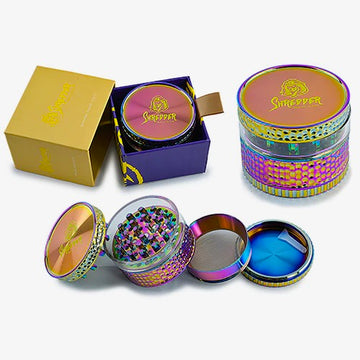 Shredder - Rainbow Window Grind Grinder (2")(50mm) Immerse yourself in a world of color and precision with the Shredder - Rainbow Window Grind Grinder. This 4-piece masterpiece features a Heavy Duty build, a compact 50mm size, and a rainbow window design that adds a vibrant touch to your herb preparation