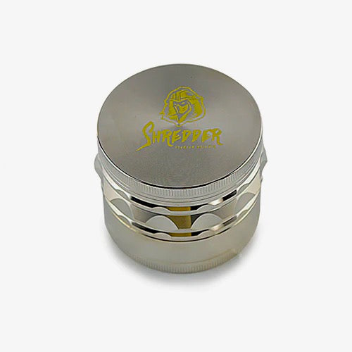 Shredder - Ridged Rim Grinder (2.5")(63mm) Grind with precision and style using the Shredder - Ridged Rim Grinder. This 4-piece marvel, featuring a robust Heavy Duty build and a spacious 63mm size with a ridged rim, adds a touch of sophistication to your herb preparation experience.